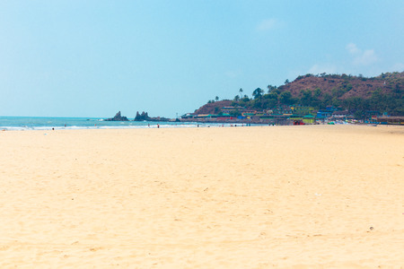 Sandy tropical beach, coastline of the sea, sunny sky and calm blue ocean. Resort Goa, India, beach Arambol. Lifestyle Travel, outdoor activities in nature.の写真素材