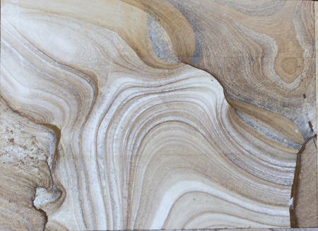 Background surface of decorative stone, sandstone with lines, volcanic material for cladding. The...