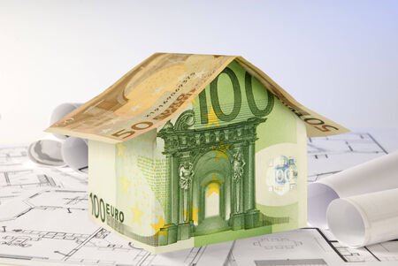 House build from Euro banknotes on blueprints の写真素材