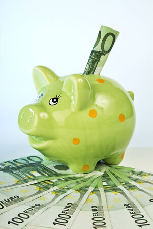 Piggy bank with 100 Euro banknotes の写真素材