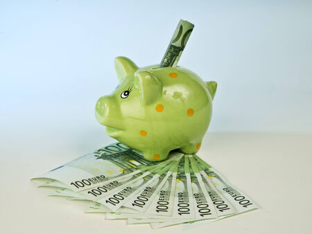 Piggy bank with 100 Euro banknotes の写真素材