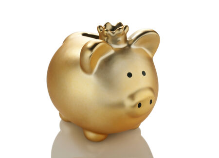 Golden piggy bank with crown の写真素材