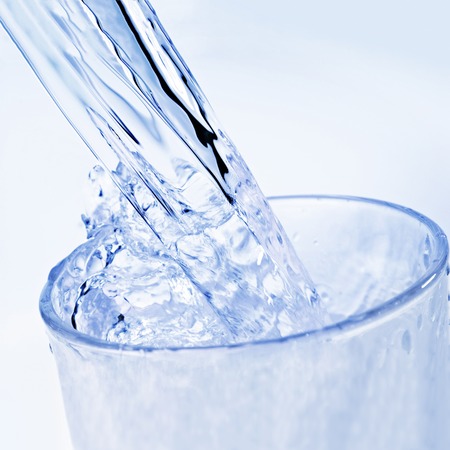 Detail of drinking water that is poured into a glass の写真素材