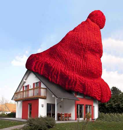 House wearing red woolen hat for keeping warm の写真素材