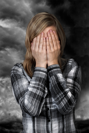 Woman holding in deep mourning hands before her face 