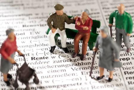 Model figures of old people on a dictionary with the word "Rente"の写真素材