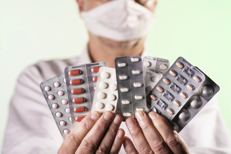 Doctor holds various drugs in the handsの写真素材