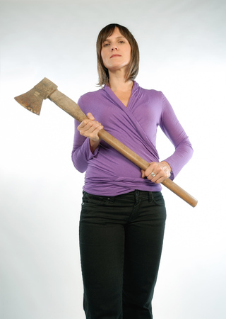 Strict woman holding a hatchet in her hands の写真素材