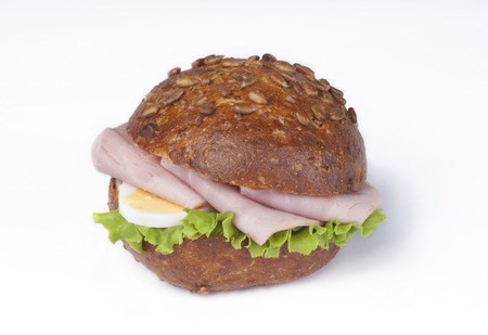 A wholemeal roll with ham, egg and saladの写真素材