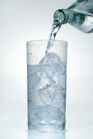 Water being poured into a glassの写真素材