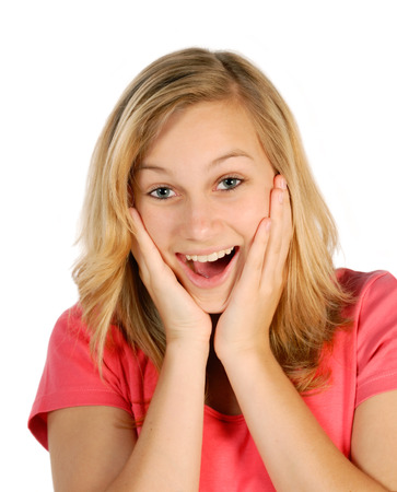 Blonde, young woman is happily surprised の写真素材
