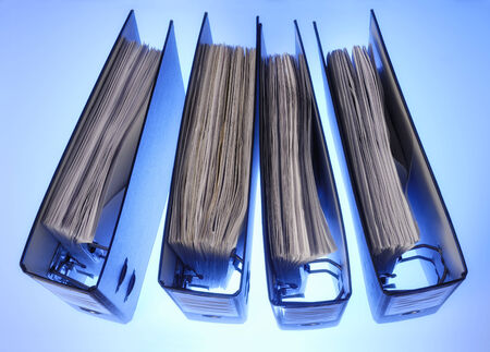 Four folders with documents seen from above の写真素材
