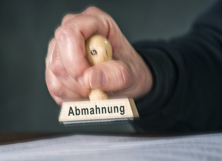 Hand with a stamp with the word dissuasionの写真素材