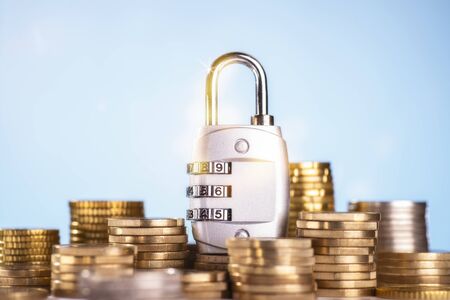 Combination lock with several stacks of coinsの写真素材