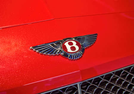 The logo of Bentley on a red car of this brand