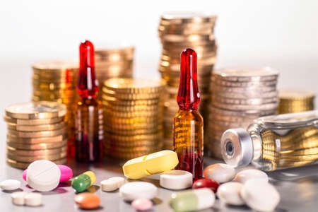Different medicines before stacking with coinsの写真素材