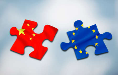 Two puzzle pieces with flags of China and Europe on abstract backgroundの写真素材