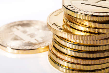A stack of cryptocurrency and a single bitcoin next to it
