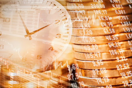 Stack of coins, stock quotes and clock as a symbol of sustainable investmentの写真素材