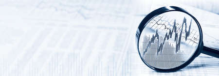 Magnifying glass with rising stock prices and free copy spaceの写真素材