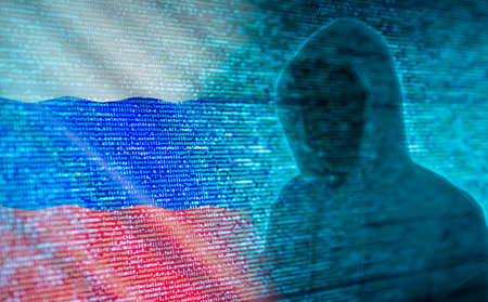 The silhouette of a hacker in front of program code and Russian flagの写真素材