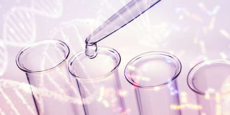Pipette and test tubes with DNA and chromosomes in backgroundの写真素材
