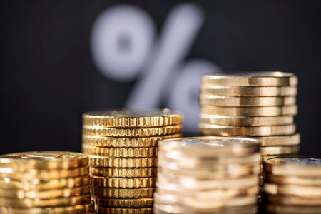 Stack with coins and percent sign in backgroundの写真素材