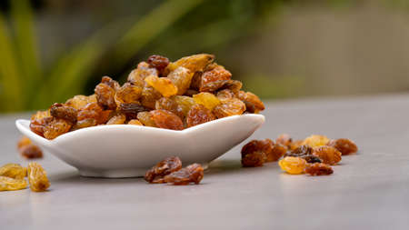 Isolated dried grapes. yellow is the highest grade on white background. with cliping path. Dried fruits yellow apricots. Vegetarian food Backgroundの写真素材