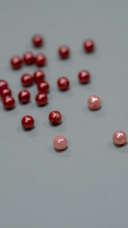 Red beads on a gray background. Shallow depth of field.