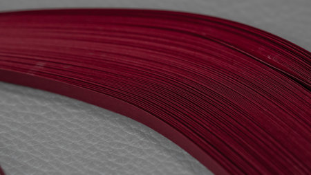 Close-up of a stack of red quilling stripes of paper. Macroの写真素材