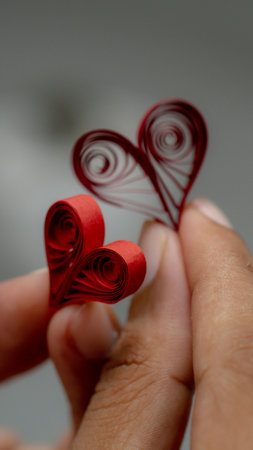 Valentine's day concept. Red paper hearts in hand. Quilling Paper Craftsの写真素材