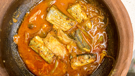 Mackerel fish curry with gravy in tomato sauce in a pot.の写真素材