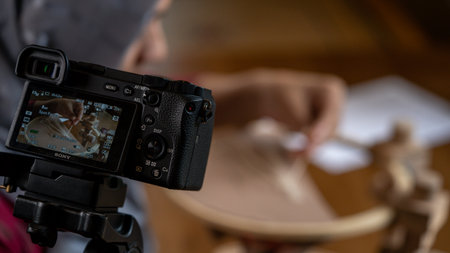 Photographer working with a camera in his studio for handmade artist. Close up.の写真素材