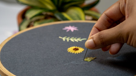 hand drawing a flower with a chalk on a blackboard at home