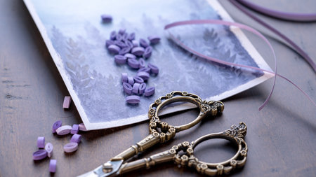 Vintage scissor on a wooden table with purple quilled roles and scissors, Crafting Time