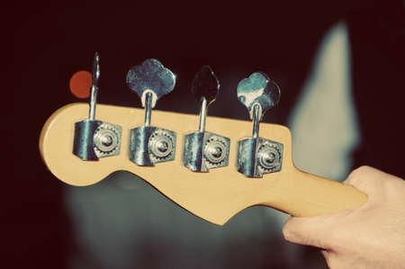Bass guitar neck in hand の写真素材