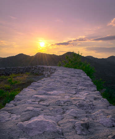 Wall leading to breathtaking view of sunsetの写真素材