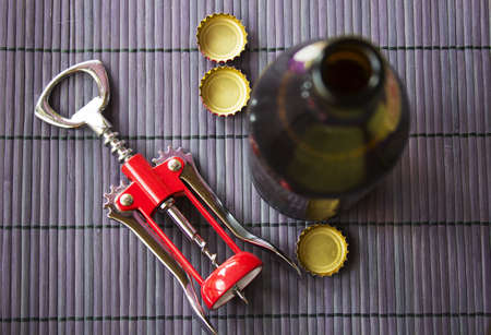cap drink opener  on wicker mat and beerの写真素材