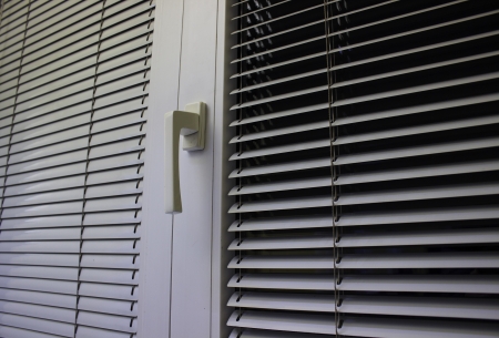 to protect against heat and sun blinds are attached to a windowの写真素材