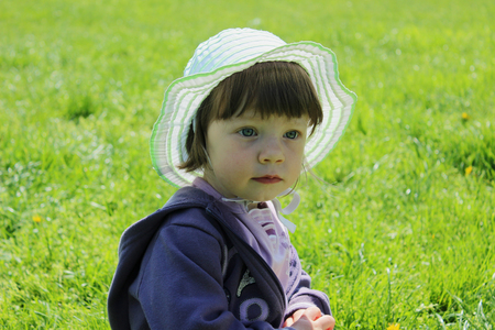 cute small girl on grass park の写真素材