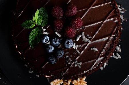 chocolate cake with fresh berries and nuts