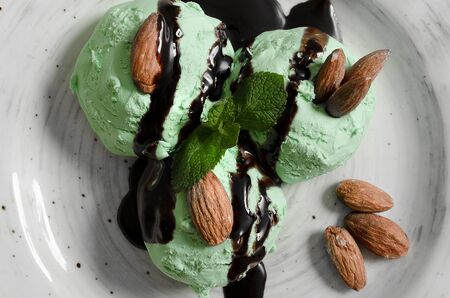 Set of ice cream scoops of different colors and flavours with berries, nuts and fruits decoration isolated on white backgroundの写真素材
