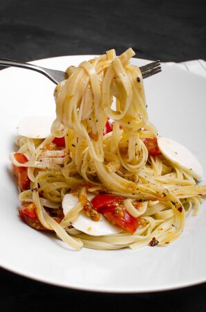 Linguine pasta in tomato sauce on a plateの写真素材