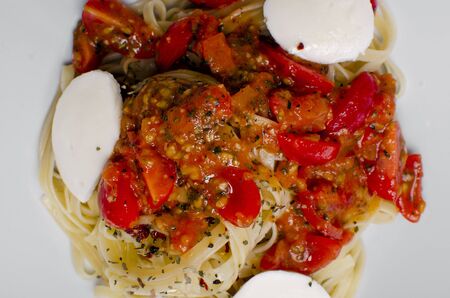 Linguine pasta in tomato sauce on a plateの写真素材