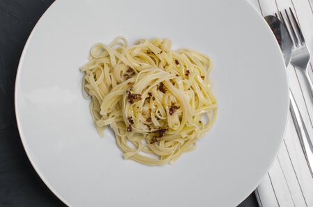 Linguine pasta in tomato sauce on a plateの写真素材