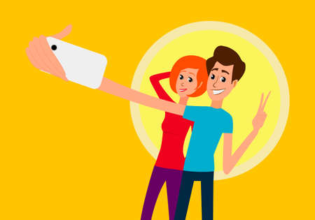 Selfie. Handsome young man looking at smartphone, holding camera and making selfie with cellphone and smiling while standing against blue background.のイラスト素材