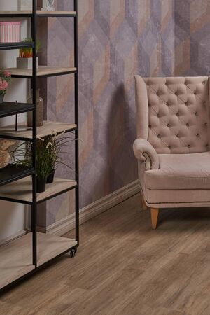 Comfortable arm chair in interior living room with pastel wall and wooden oak floor.の写真素材