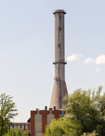 Smokestack with blue sky and treesの写真素材