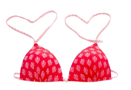 Red bikini top with heart shape isolated on whiteの写真素材