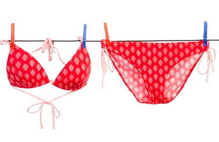 Drying red bikini with white backgroundの写真素材